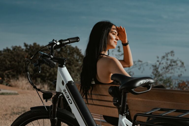 woman in black tank top riding on black bicycle during daytime