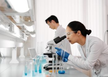 Inżynier biomedyczny przy stanowisku laboratoryjnym badającym prototyp urządzenia medycznego